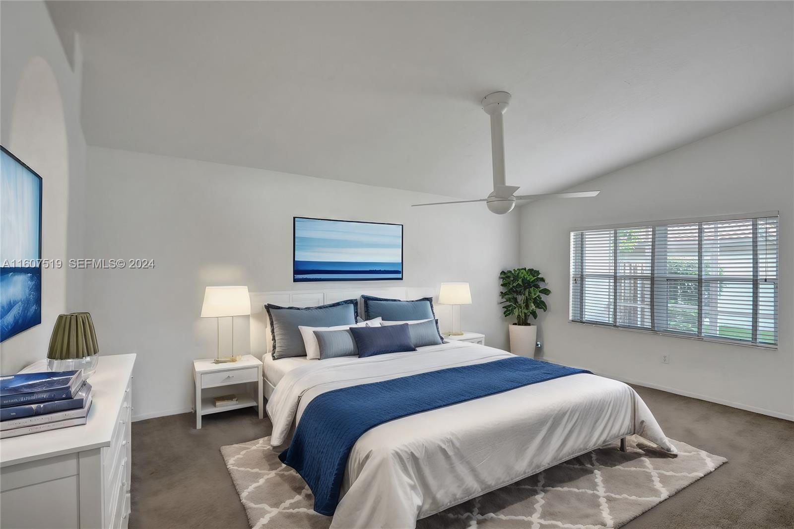 22740 Royal Crown Terrace East Boca Raton, FL 33433 - Photo 14 of 26 a bedroom with a large bed and a window