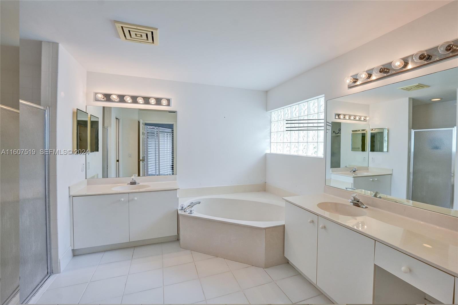 22740 Royal Crown Terrace East Boca Raton, FL 33433 - Photo 16 of 26 a bathroom with a bathtub sink and mirror