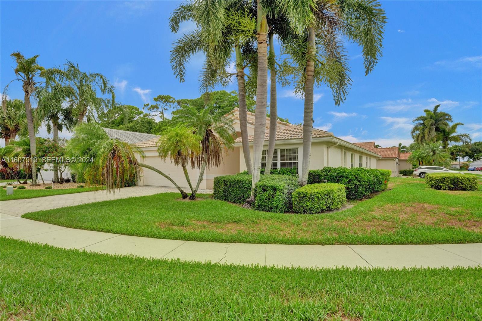 22740 Royal Crown Terrace East Boca Raton, FL 33433 - Photo 20 of 26 a view of a garden with a building in the background