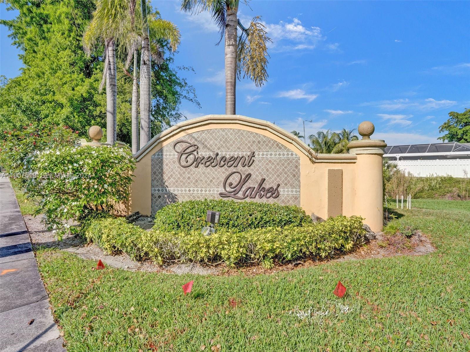22740 Royal Crown Terrace East Boca Raton, FL 33433 - Photo 25 of 26 a view of a sign board with flower plants