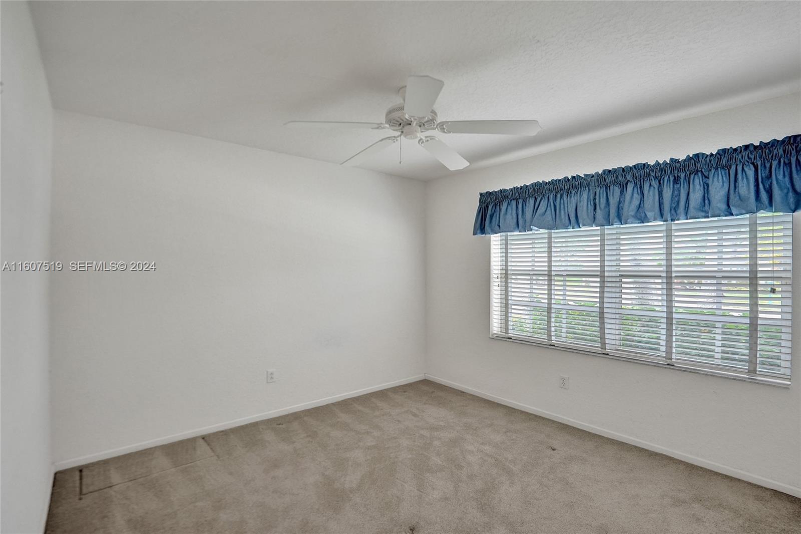 22740 Royal Crown Terrace East Boca Raton, FL 33433 - Photo 9 of 26 an empty room with chandelier fan