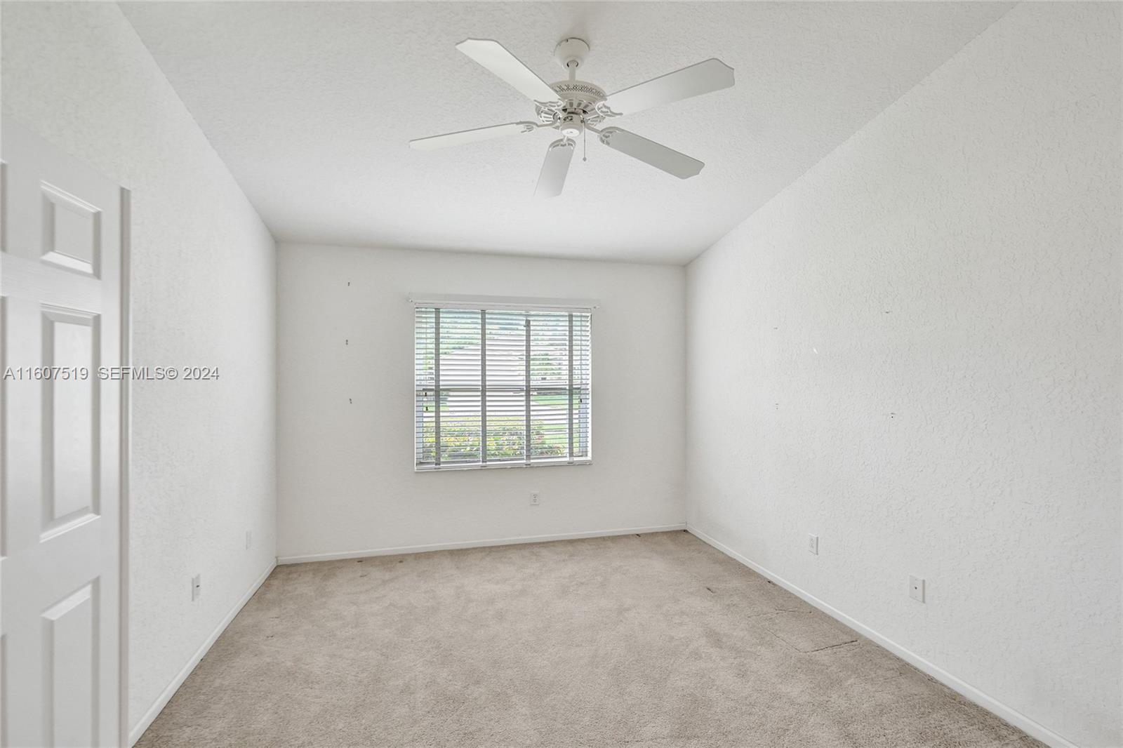 22740 Royal Crown Terrace East Boca Raton, FL 33433 - Photo 10 of 26 an empty room with fan and windows