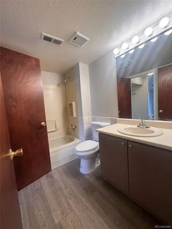 a view of a kitchen with wooden floor and a hallway