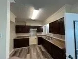 a view of kitchen with cabinets