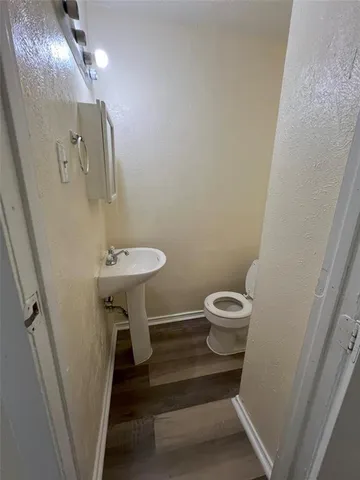 a bathroom with a sink a toilet a mirror and vanity