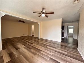 3601 Aloha Circle Mesquite, TX 75150 - Photo 5 of 22 a view of a livingroom with wooden floor and a ceiling fan