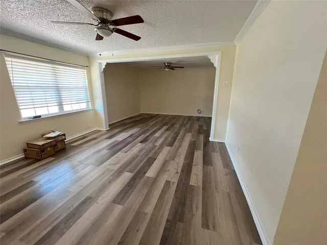 a view of a room with wooden floor and a window