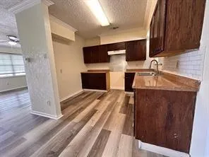 a kitchen with a refrigerator and a sink