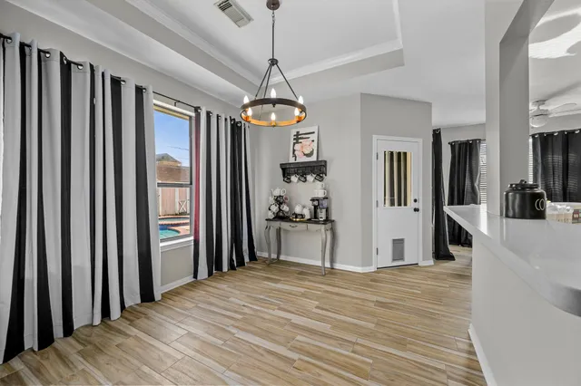 a view of a room with wooden floor and windows