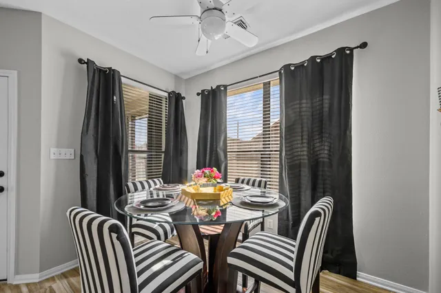 a view of a dining room with furniture and window