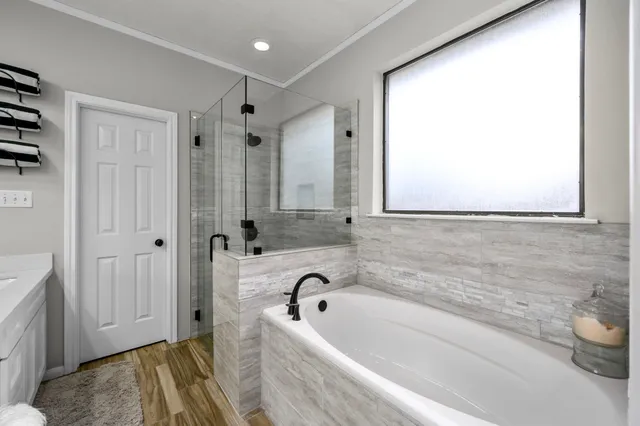 a bathroom with a tub and a sink