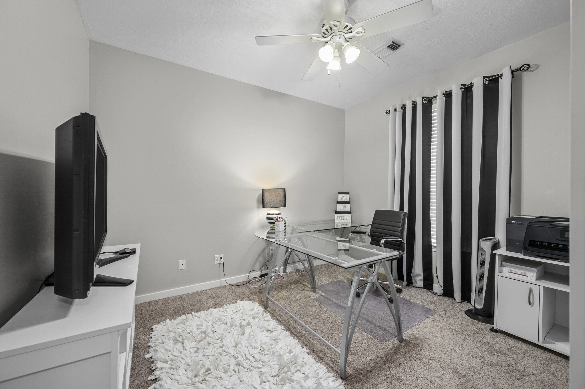 12302 Fisher Drive Mont Belvieu, TX 77523 - Photo 19 of 23 a view of a workspace with furniture and a flat screen tv