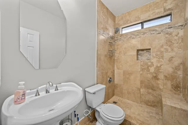 a bathroom with a sink toilet and shower