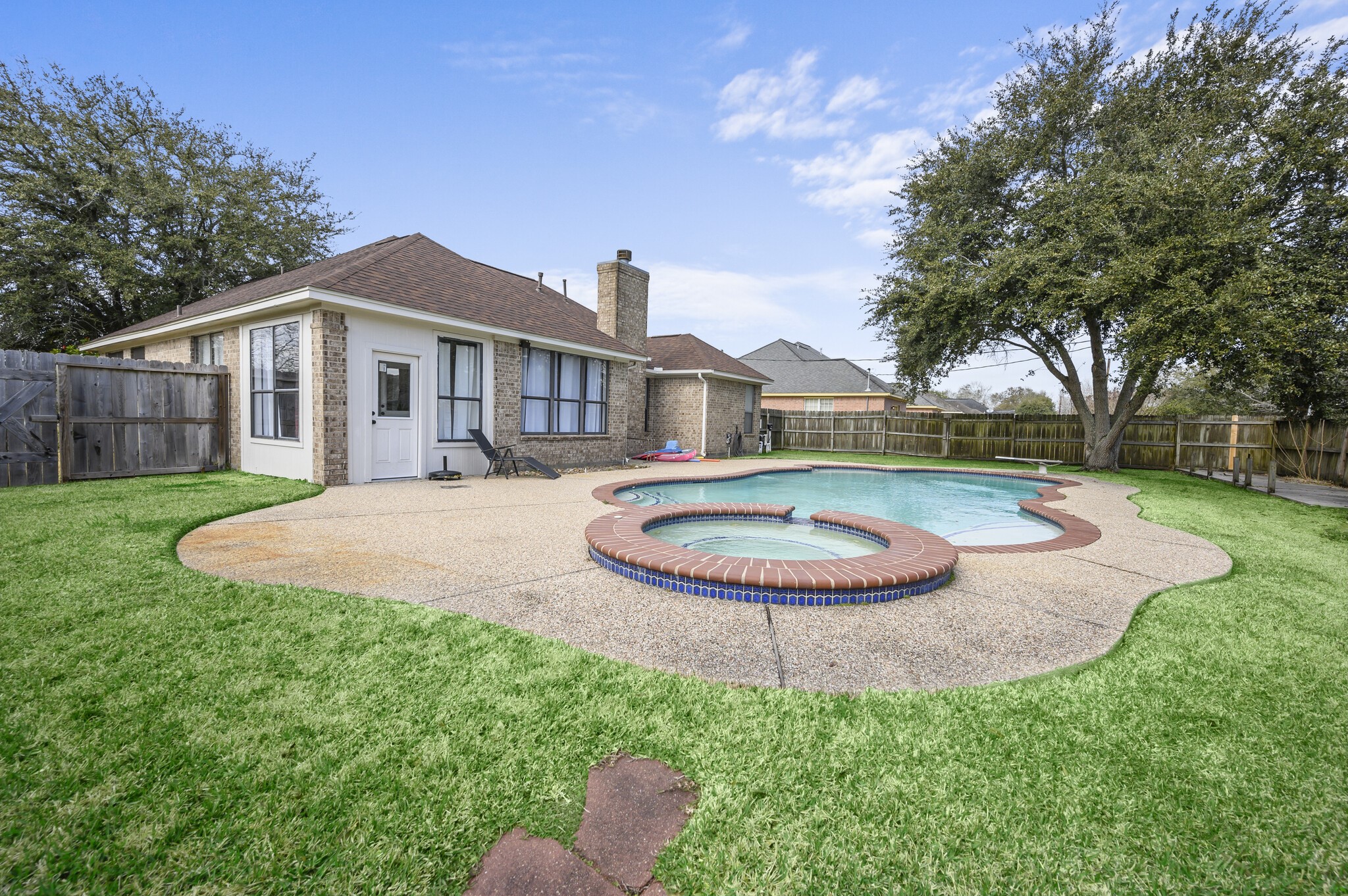12302 Fisher Drive Mont Belvieu, TX 77523 - Photo 23 of 23 a view of a house with a swimming pool and yard