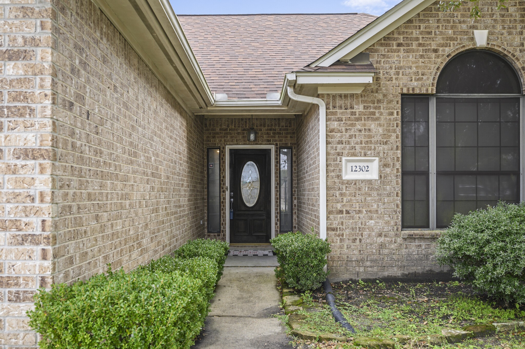 12302 Fisher Drive Mont Belvieu, TX 77523 - Photo 3 of 23 a front view of a house with garden