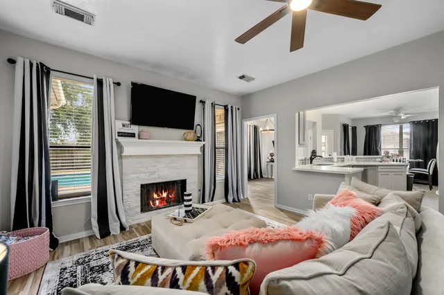a living room with furniture fireplace and flat screen tv