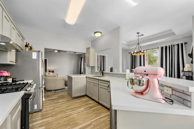 a kitchen with stove and refrigerator