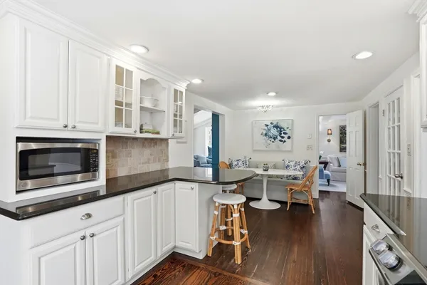 a kitchen with granite countertop a sink and a stove
