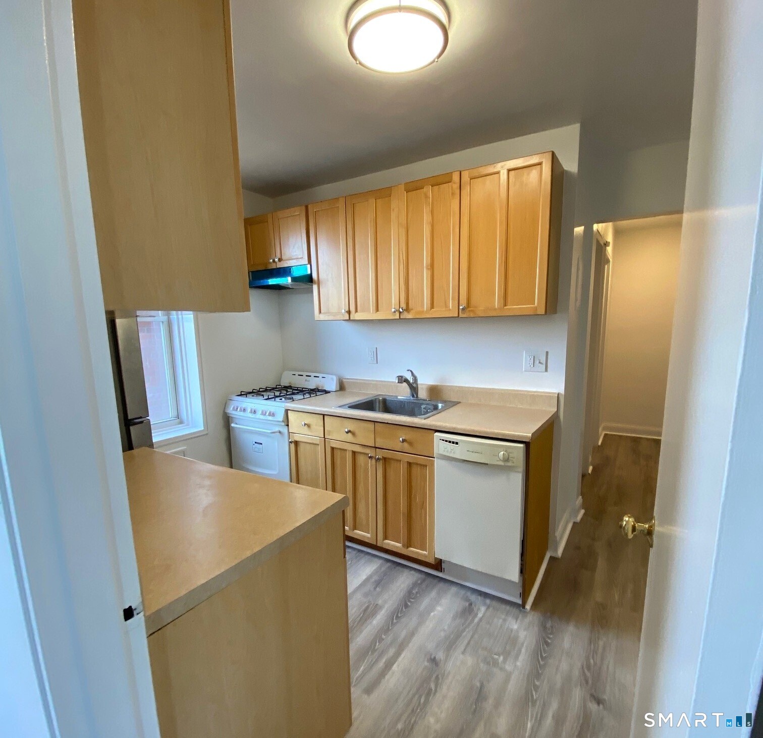 46 Prospect Avenue, Unit 3D Norwalk, CT 06850 - Photo 11 of 24 a kitchen with stainless steel appliances a refrigerator sink and wooden cabinets