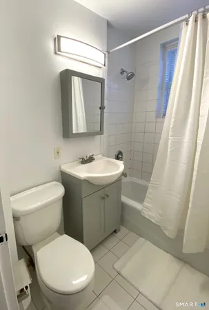 a bathroom with a toilet sink and shower