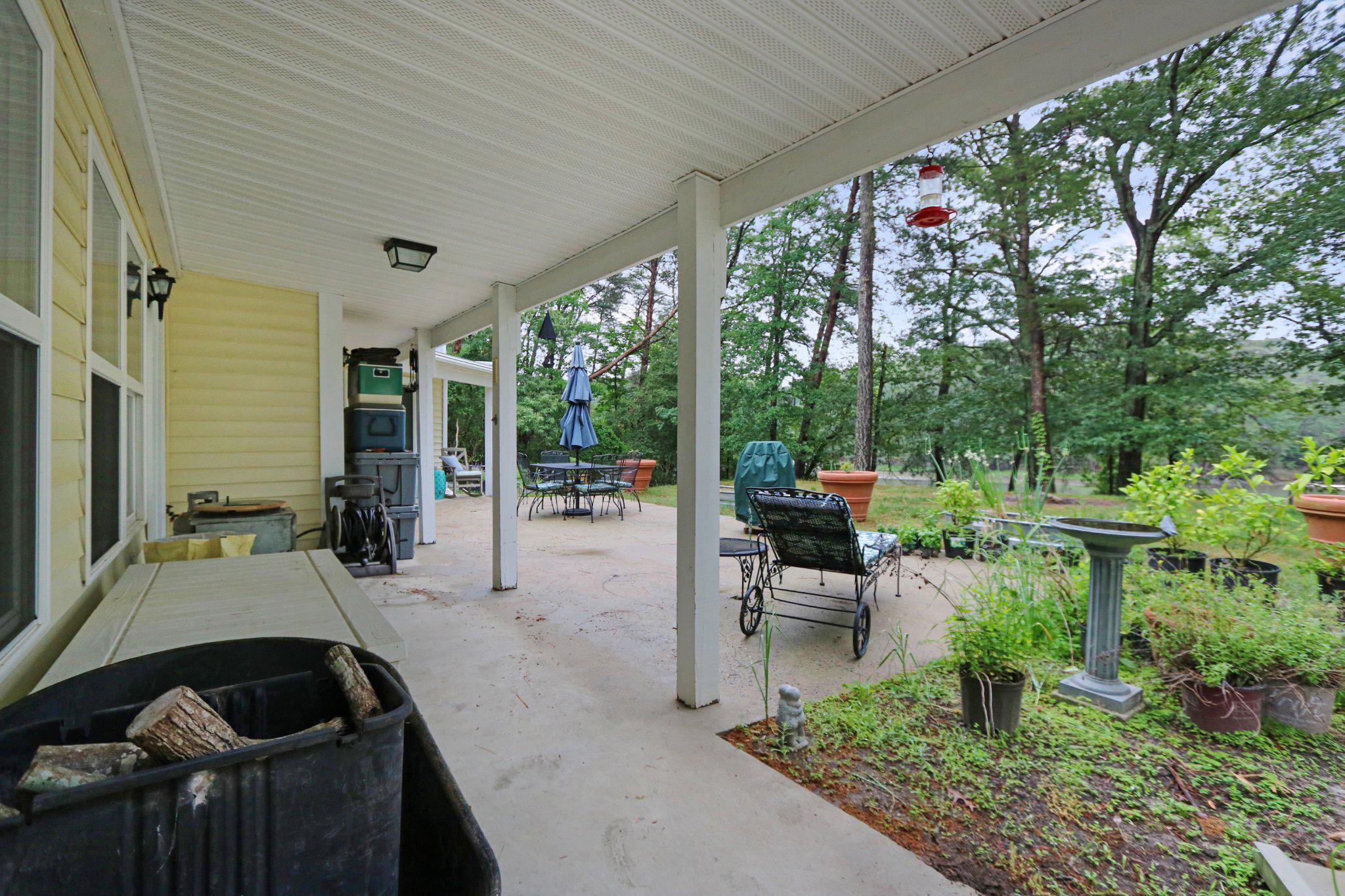 13431 Solitude Trail Machipongo, VA 23405 - Photo 20 of 32 Serene porch with lush greenery views.