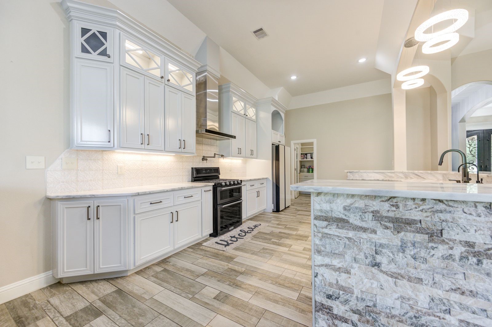 21038 Angus Drive Cleveland, TX 77328 - Photo 14 of 49 a large kitchen with stainless steel appliances kitchen island granite countertop a sink and cabinets