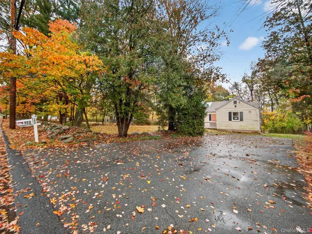 a white house that has a tree in front of it