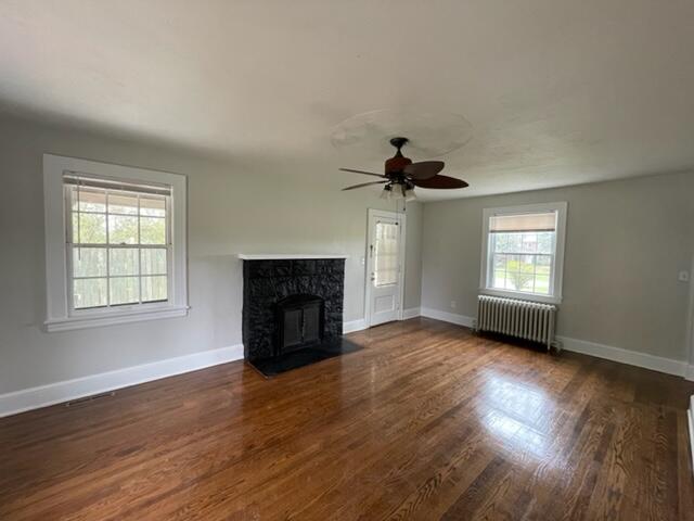 3607 Cove Road Roanoke, VA 24017 - Photo 4 of 9 an empty room with wooden floor fireplace and windows