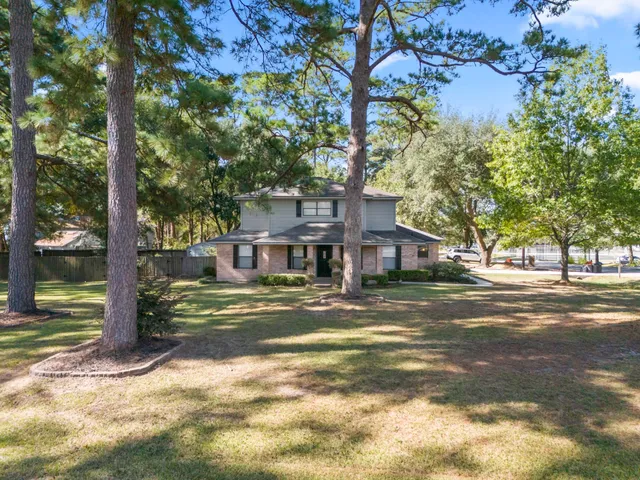 a view of a large trees in front of a house