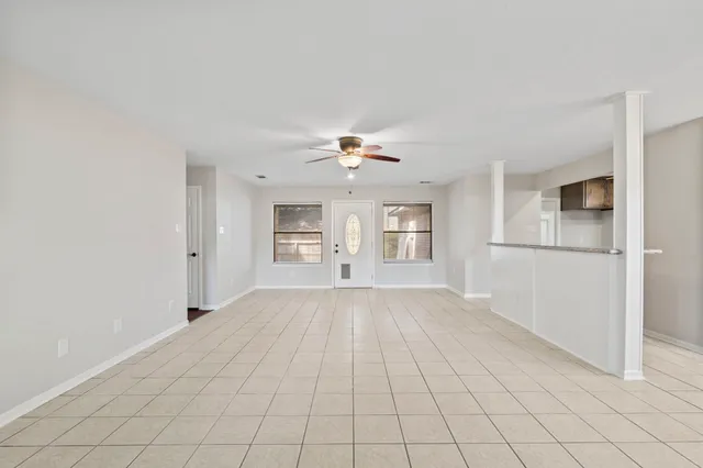 a view of a livingroom with a ceiling fan and window