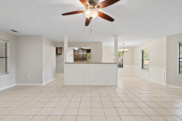 a view of a kitchen with an empty space and a window