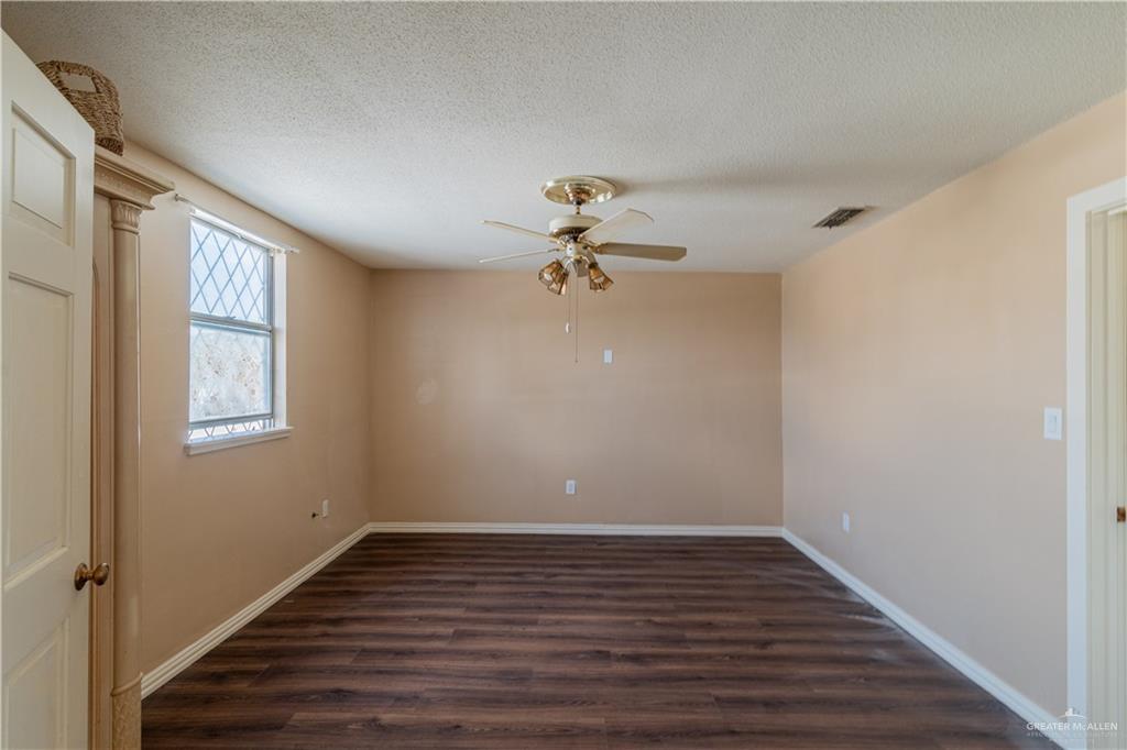 1004 South Border Avenue Weslaco, TX 78596 - Photo 11 of 20 a view of a livingroom with wooden floor and a ceiling fan