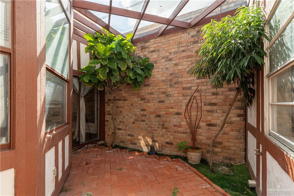 1004 South Border Avenue Weslaco, TX 78596 - Photo 15 of 20 a plant is in front of a glass door