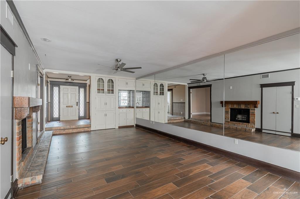 1004 South Border Avenue Weslaco, TX 78596 - Photo 3 of 20 a view of a livingroom with wooden floor and a fireplace