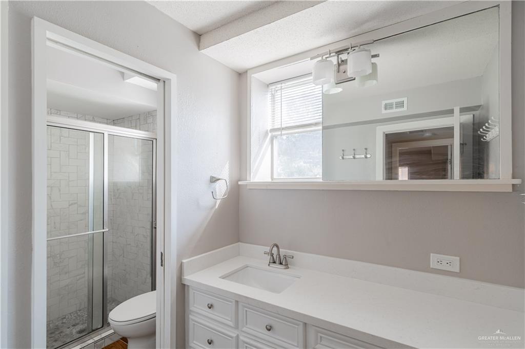 1004 South Border Avenue Weslaco, TX 78596 - Photo 7 of 20 a bathroom with a sink toilet and shower