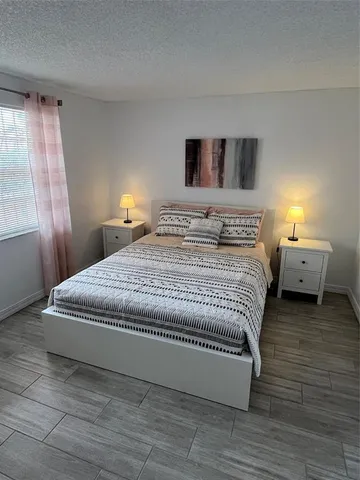 a bedroom with a bed and a night stand