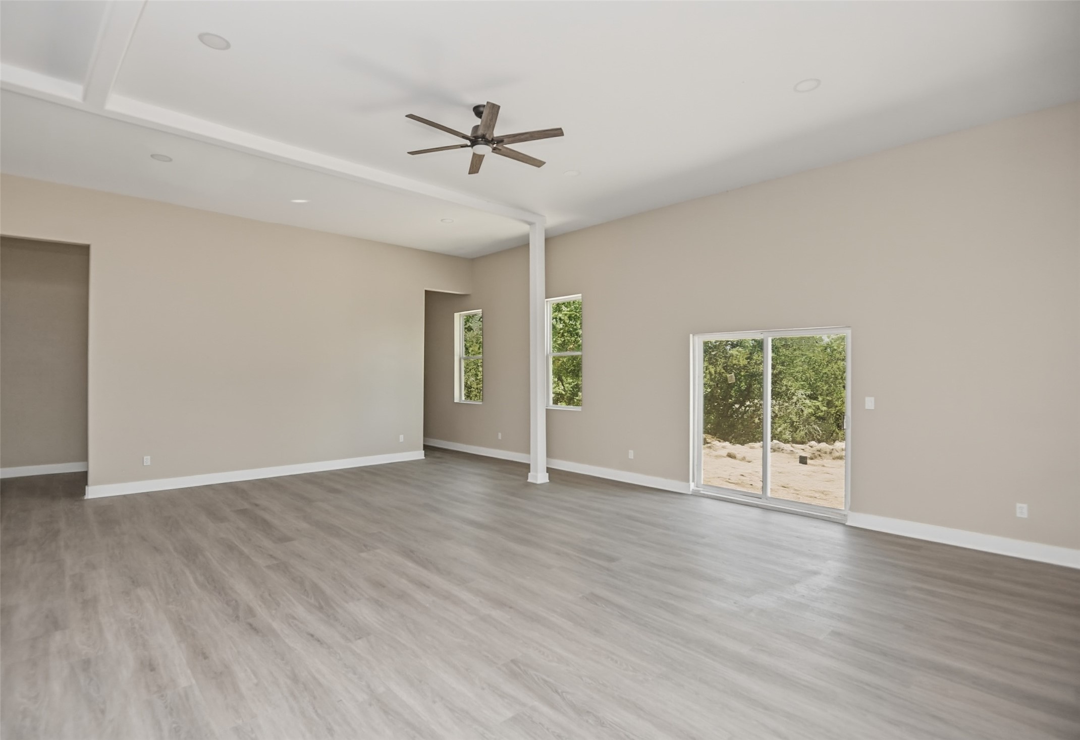 14300 Fallen Timber Drive Austin, TX 78734 - Photo 19 of 35 an empty room with wooden floor fan and windows