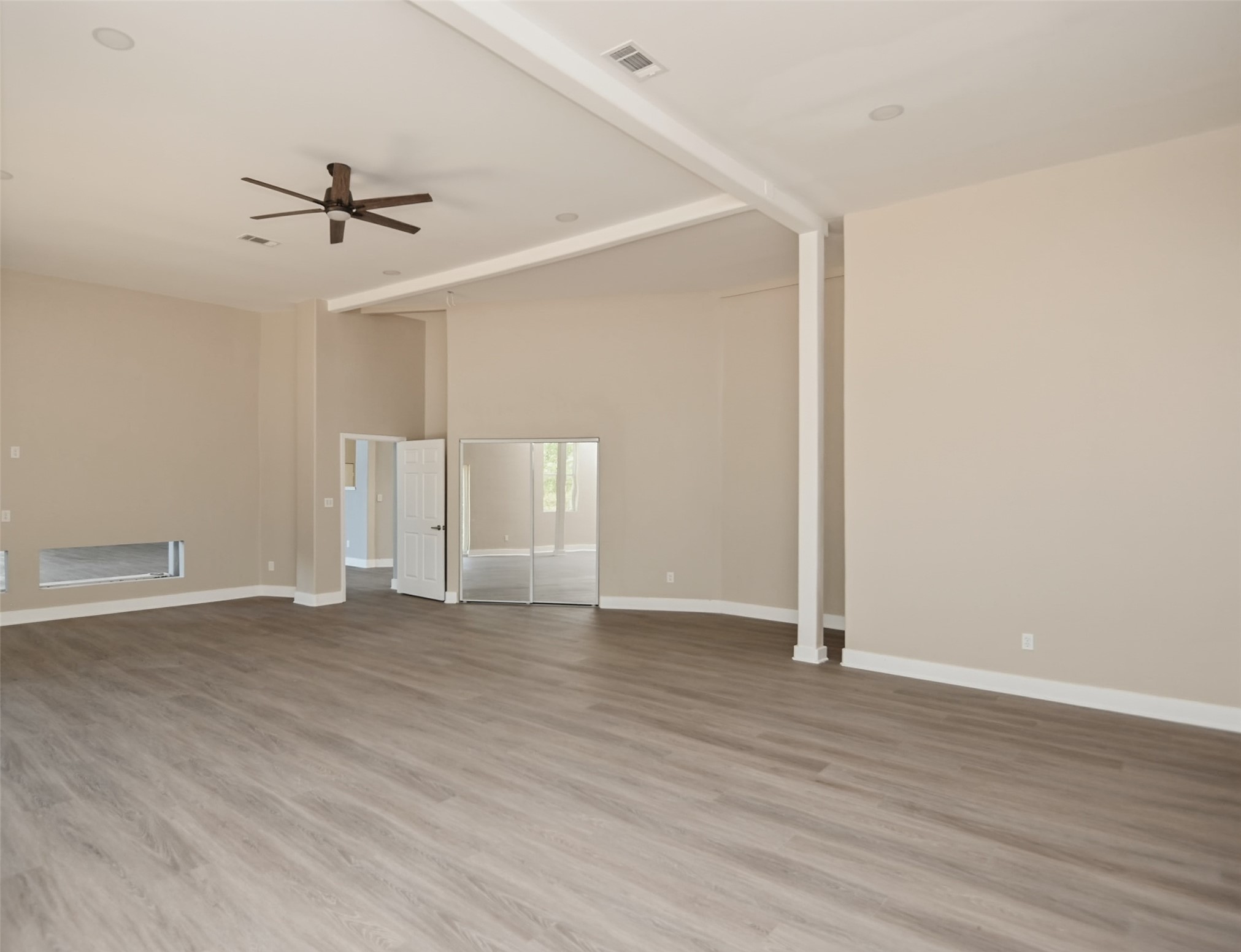 14300 Fallen Timber Drive Austin, TX 78734 - Photo 20 of 35 an empty room with wooden floor ceiling fan and windows