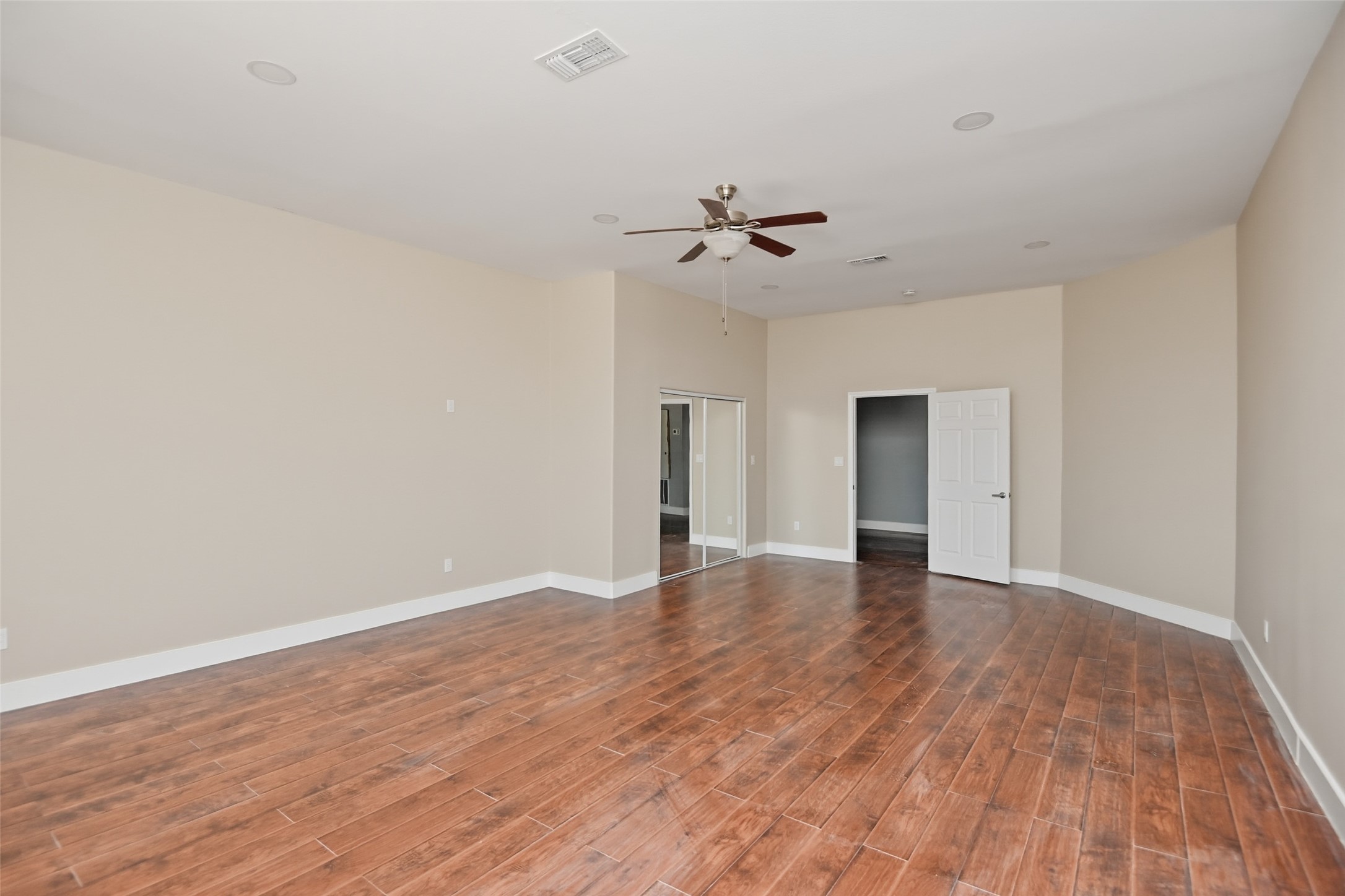 14300 Fallen Timber Drive Austin, TX 78734 - Photo 34 of 35 a view of empty room with wooden floor and ceiling fan