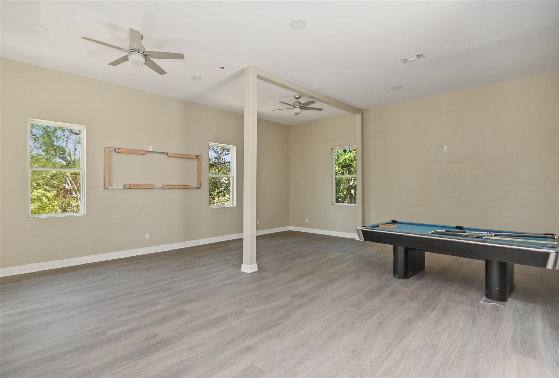 14300 Fallen Timber Drive Austin, TX 78734 - Photo 8 of 35 an empty room with windows and ceiling fan