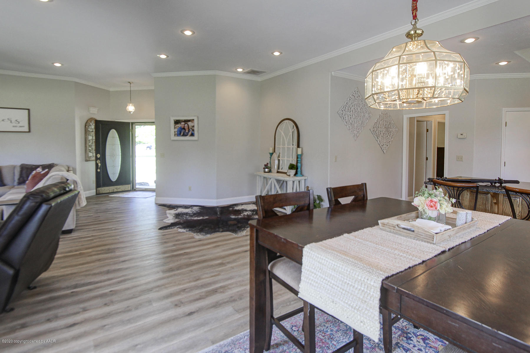 9000 Red Wing Road Amarillo, TX 79119 - Photo 15 of 33 a dining room with wooden floor a chandelier a wooden table and chairs
