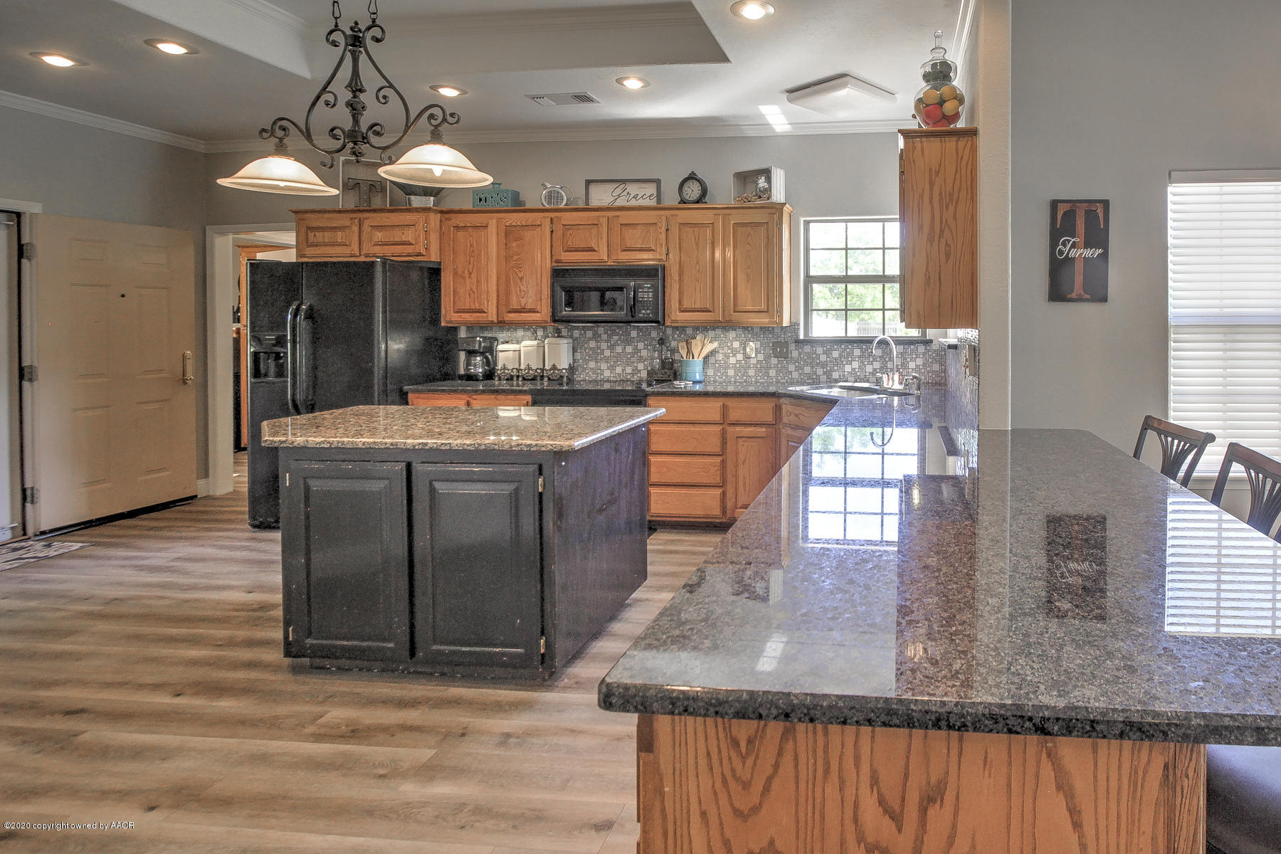 9000 Red Wing Road Amarillo, TX 79119 - Photo 16 of 33 a kitchen with stainless steel appliances granite countertop a sink a stove and a wooden floors