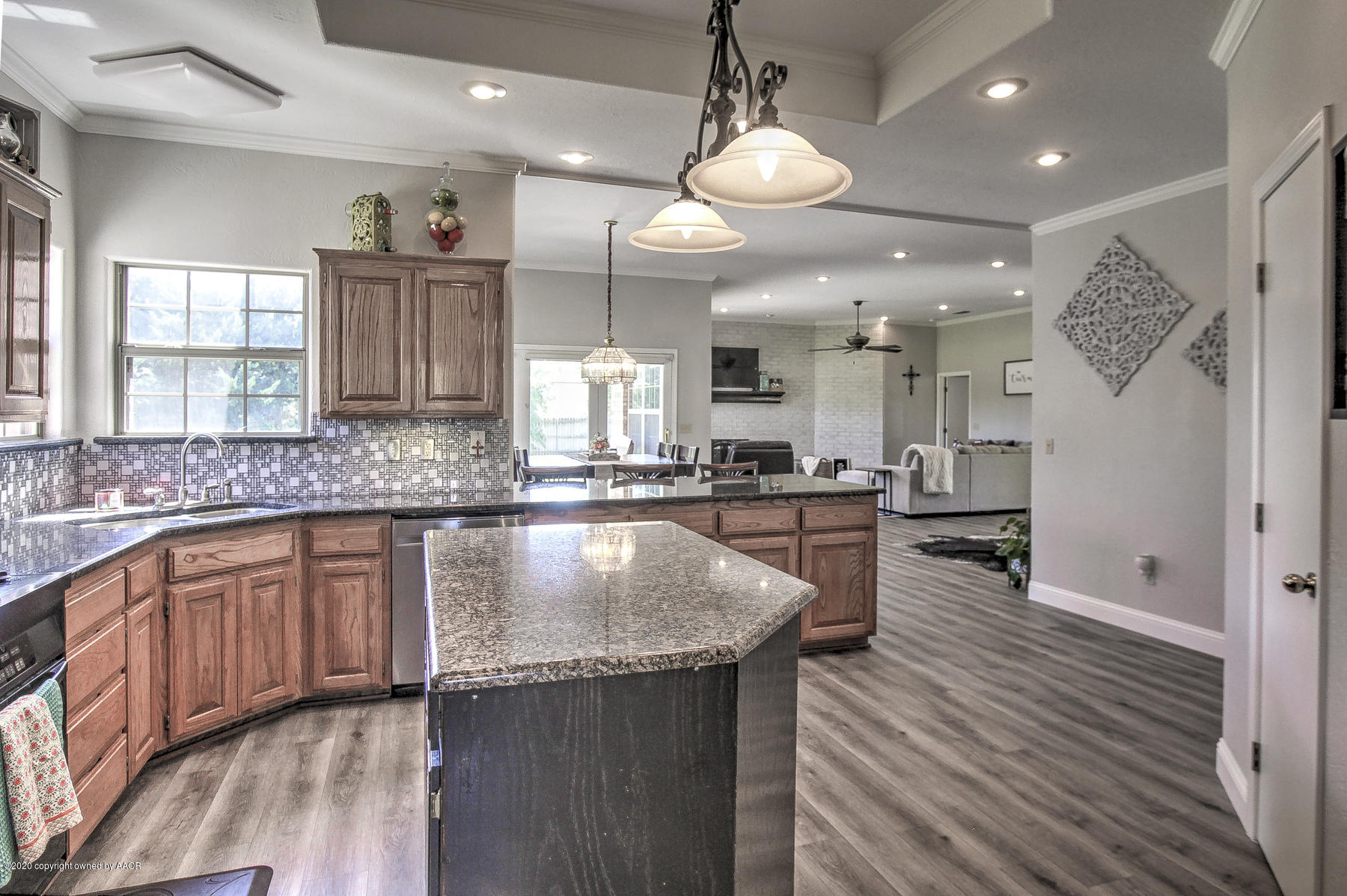 9000 Red Wing Road Amarillo, TX 79119 - Photo 17 of 33 a large kitchen with stainless steel appliances granite countertop a lot of counter space and wooden floors