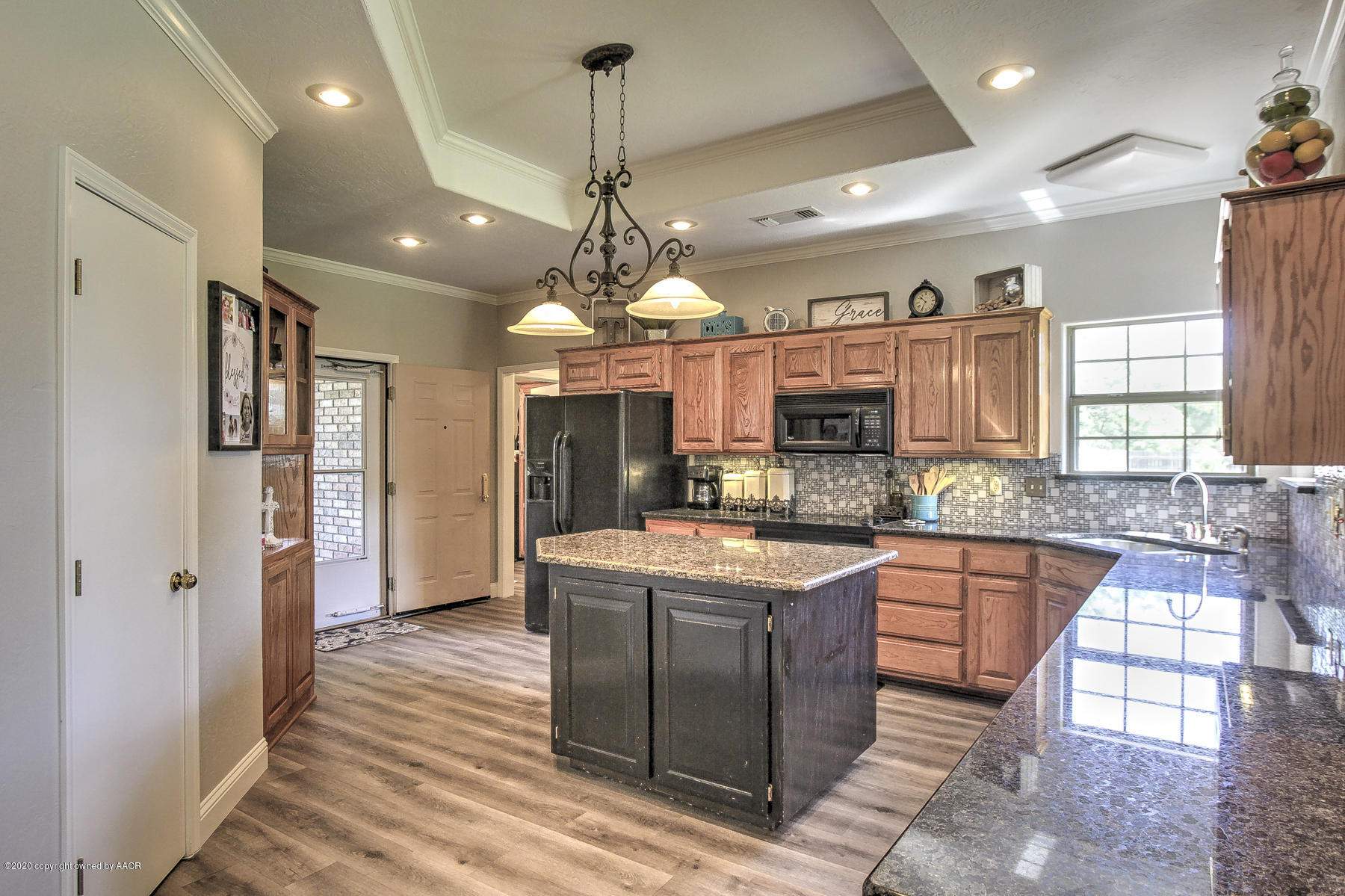 9000 Red Wing Road Amarillo, TX 79119 - Photo 18 of 33 a large kitchen with granite countertop a large island in the center and stainless steel appliances