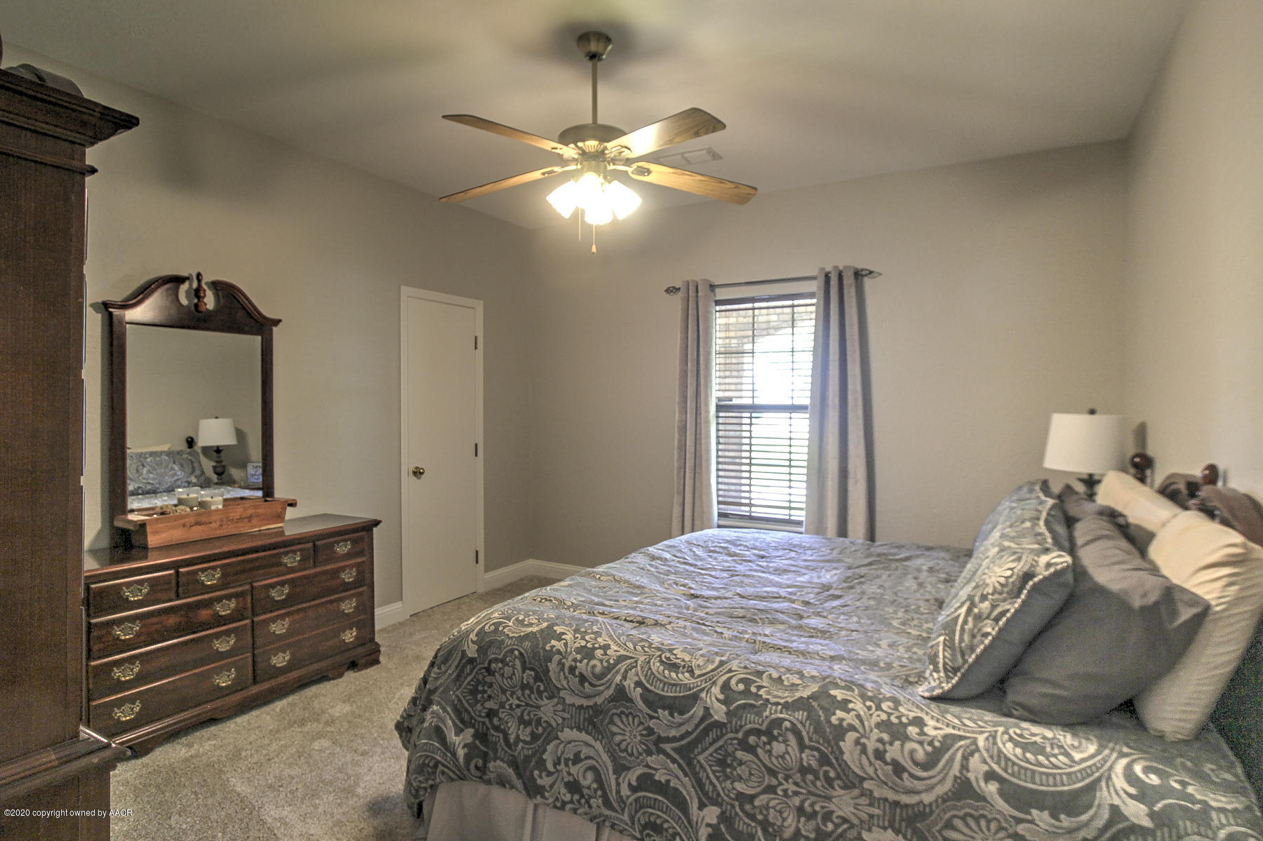9000 Red Wing Road Amarillo, TX 79119 - Photo 19 of 33 a bedroom with a bed and a chandelier
