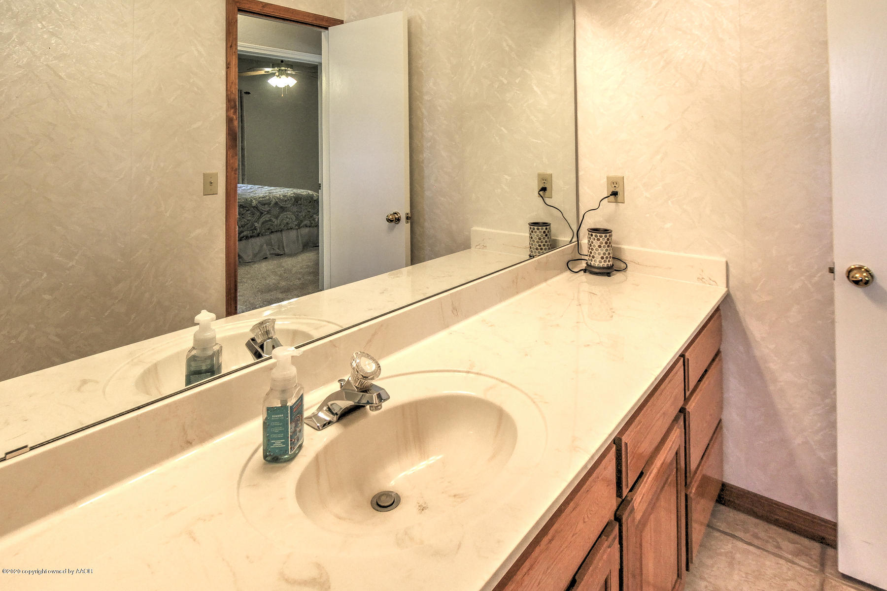 9000 Red Wing Road Amarillo, TX 79119 - Photo 20 of 33 a bathroom with a sink and a mirror