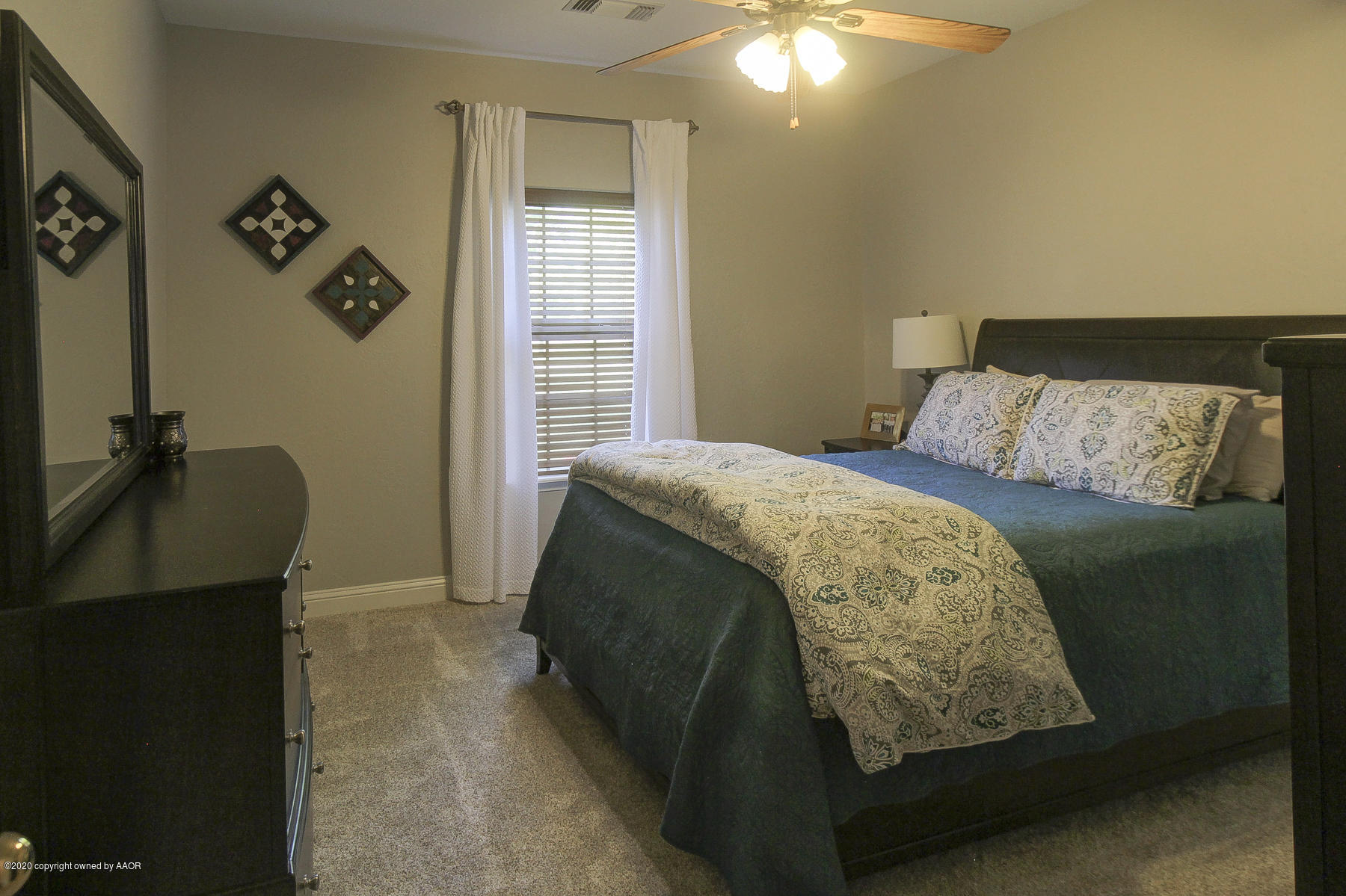 9000 Red Wing Road Amarillo, TX 79119 - Photo 22 of 33 a bedroom with a bed and painting on the wall