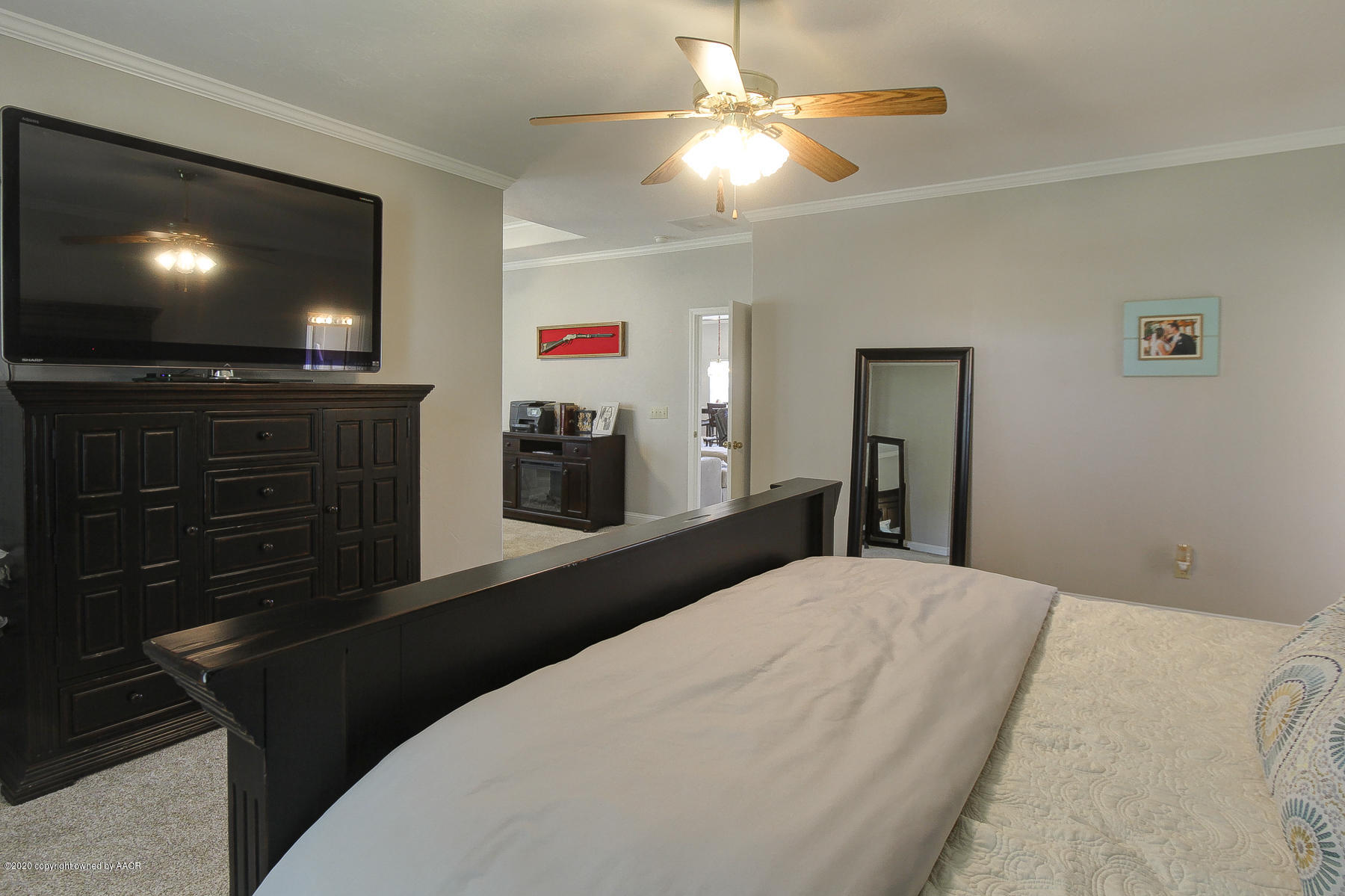 9000 Red Wing Road Amarillo, TX 79119 - Photo 25 of 33 a bedroom with a bed and a flat screen tv