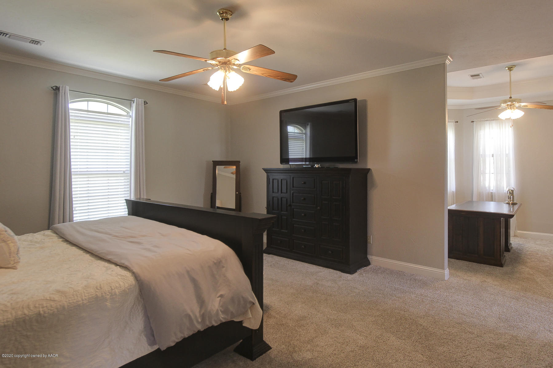 9000 Red Wing Road Amarillo, TX 79119 - Photo 26 of 33 a bedroom with a bed and a television