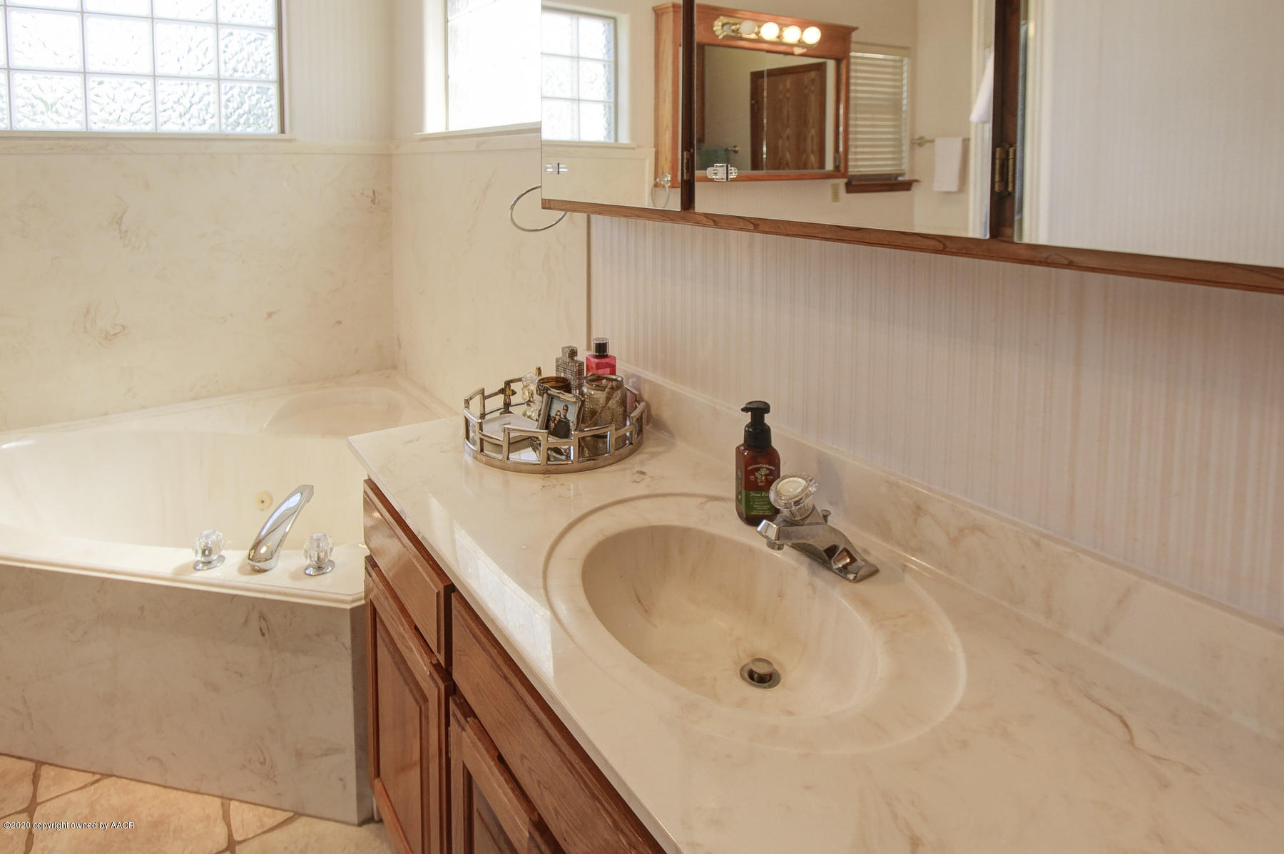 9000 Red Wing Road Amarillo, TX 79119 - Photo 27 of 33 a bathroom with a sink and a mirror